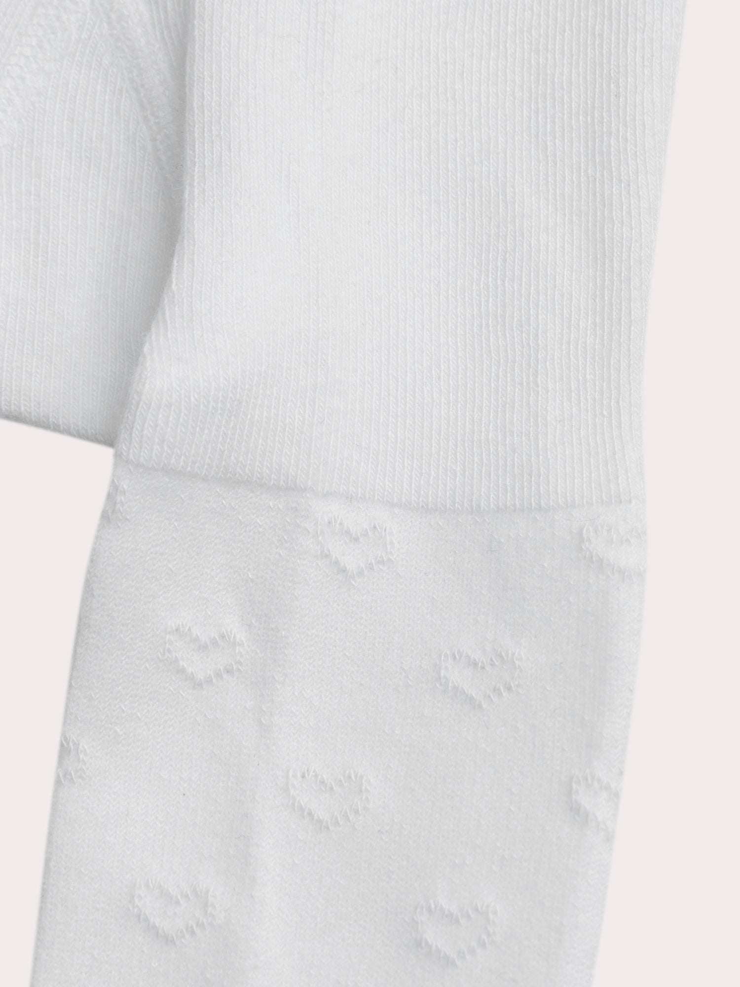 Collant blanc à cœurs ajourés pour bébé fille